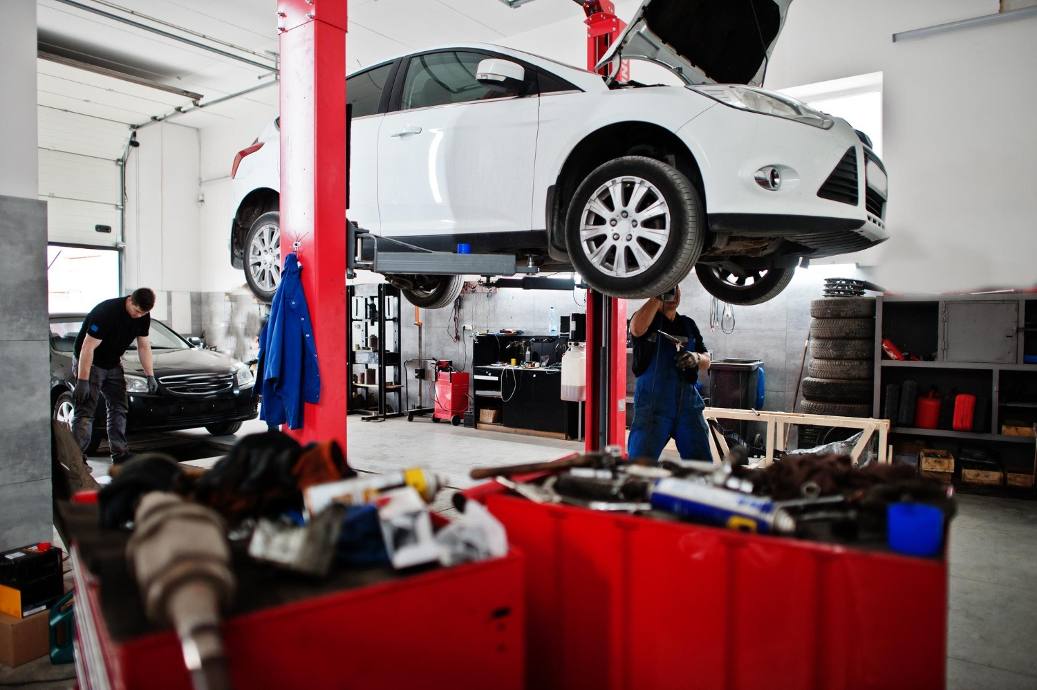 Vehicle raised on a lift inside the Cruz Automotive repair shop